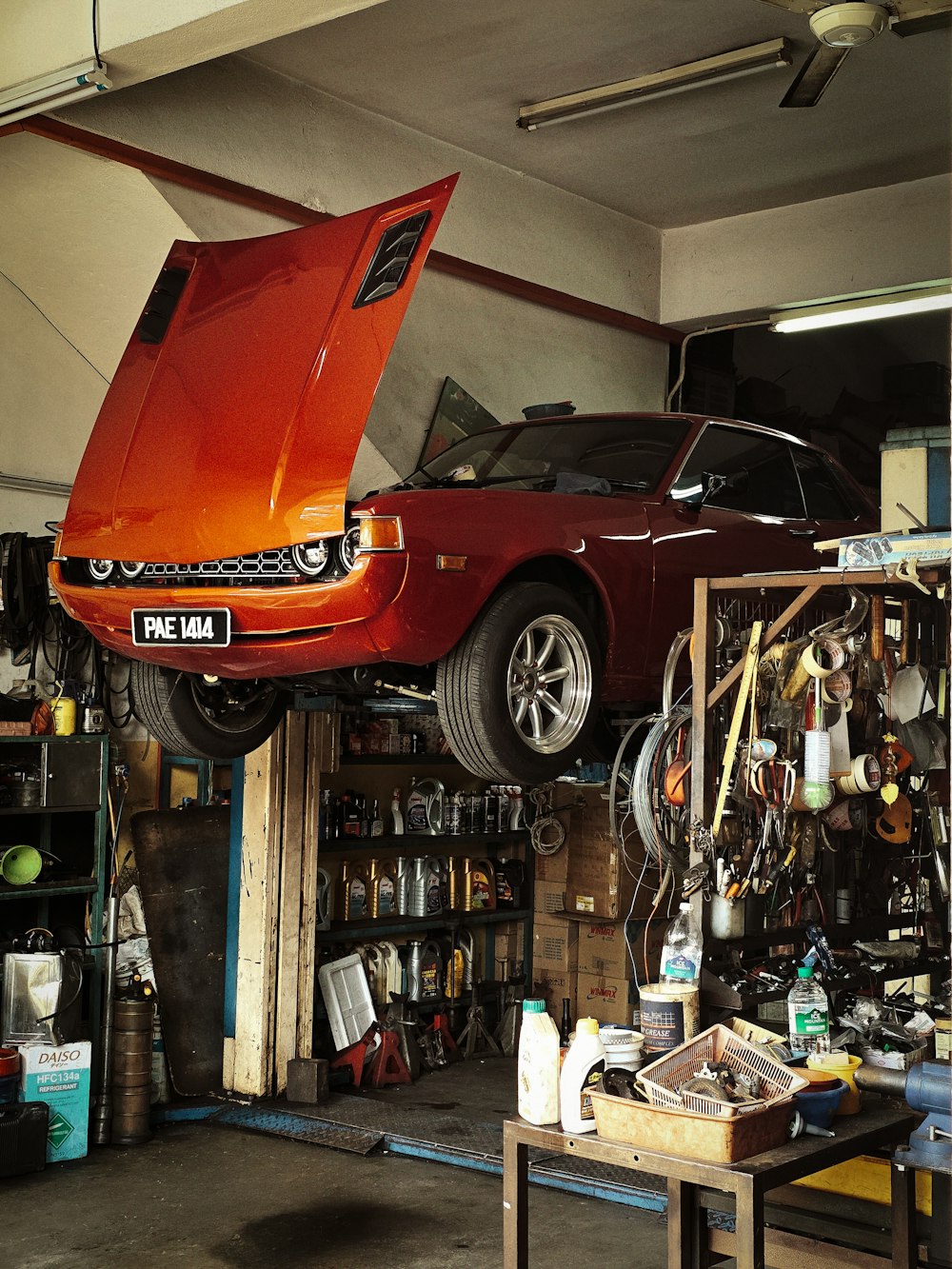 Classic coupe raised on the lift for a full inspection at AUTOEXPERT