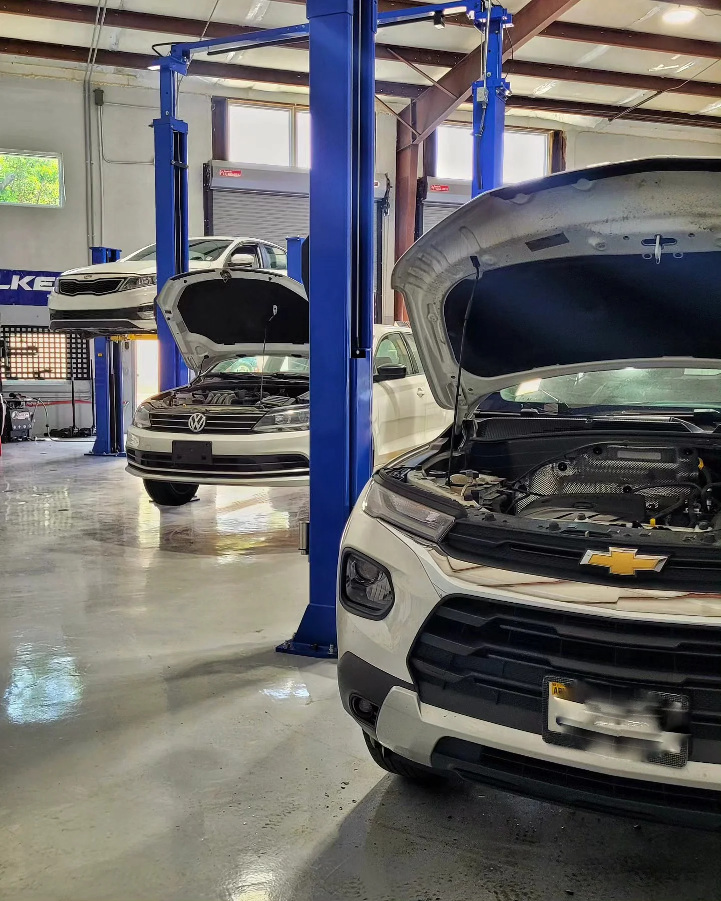 AUTOEXPERT auto repair shop bay in Virginia Beach, VA, full of vehicles being serviced