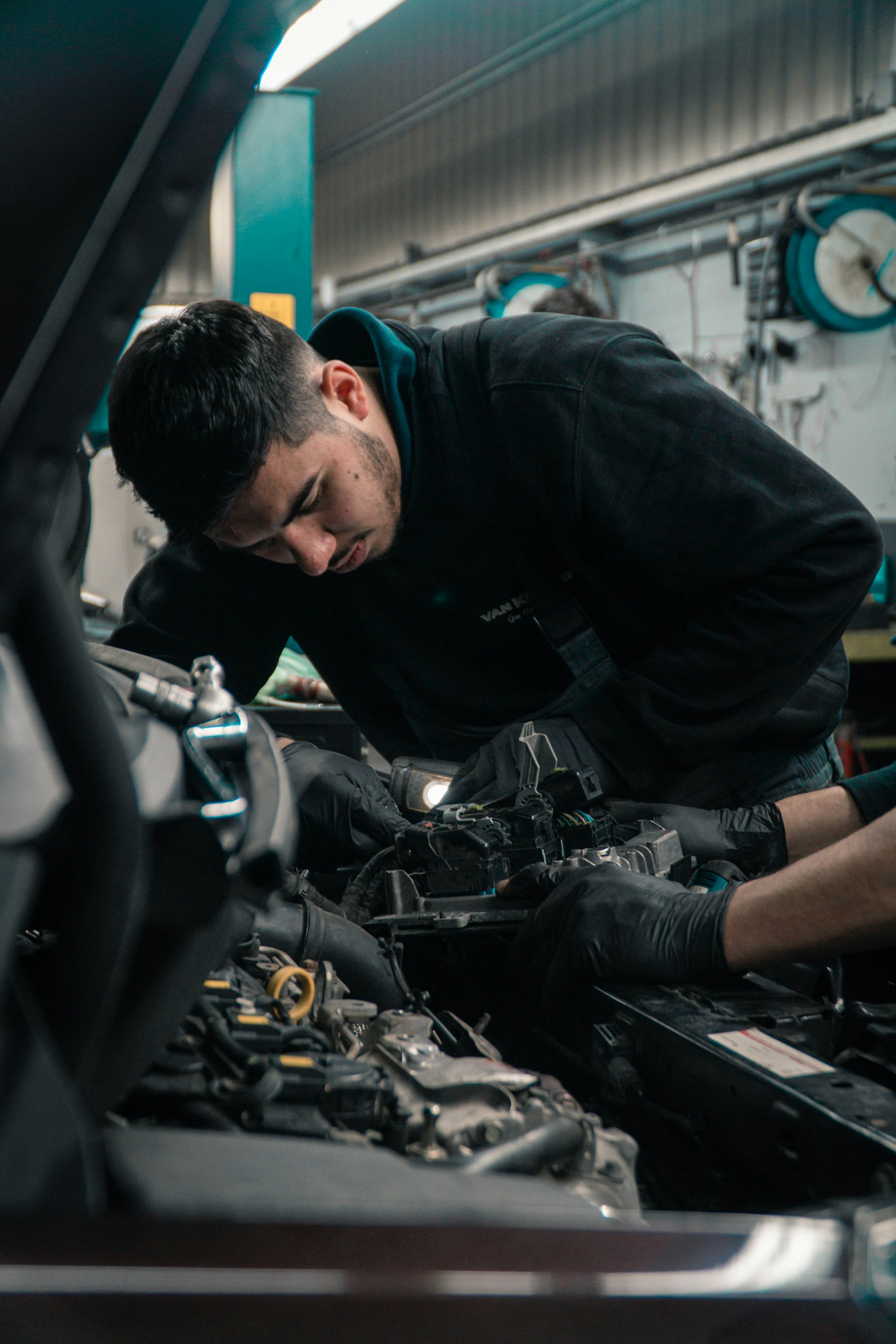Mechanic performing engine diagnostics and repair at AUTOEXPERT in Virginia Beach